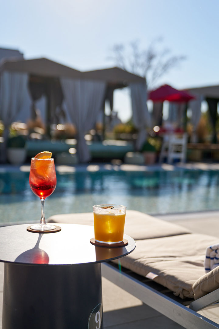 Elegant restaurant interior featuring plush seating, golden wall art, and large windows inviting natural light.
